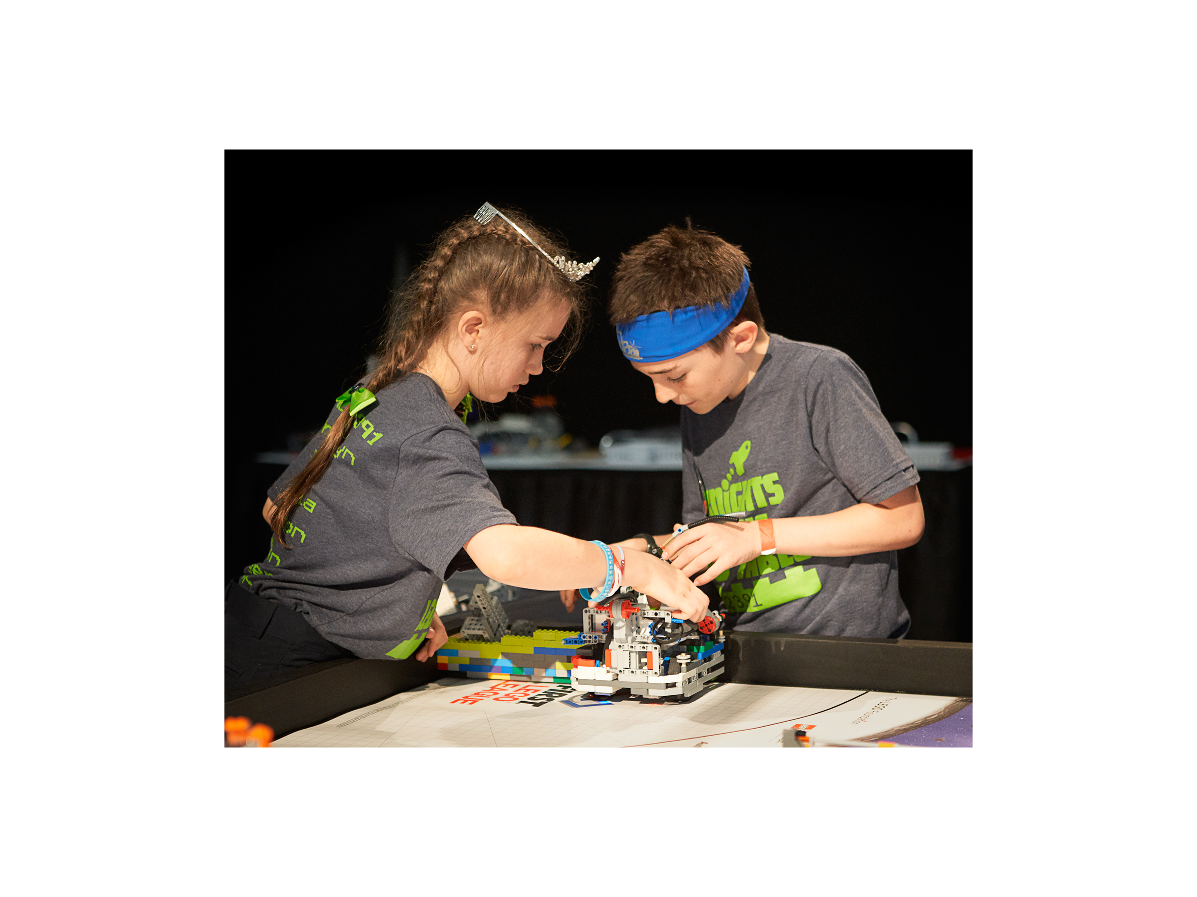 Students building a LEGO robot at a STEM Competition